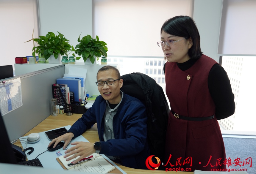 王麗杰（右）和同事進行項目交流。人民網記者 楊文娟攝